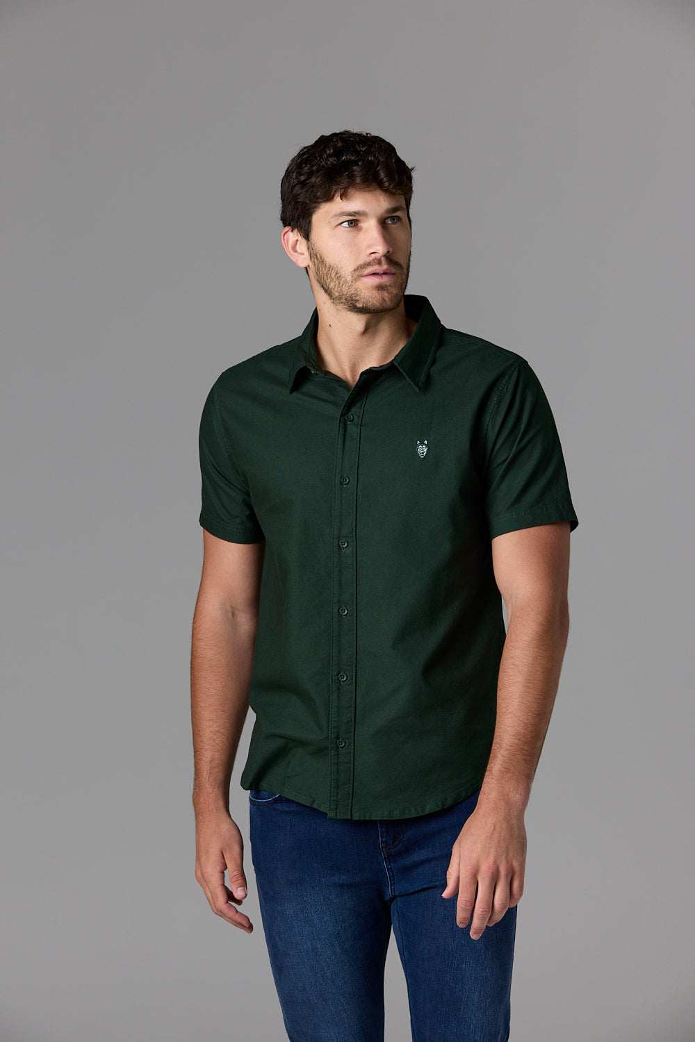 Man wearing a dark green shirt and jeans.
